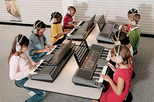 Students playing electric keyboards.