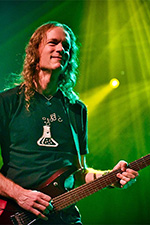 Professional drummer Ali Jackson playing drum set in concert.